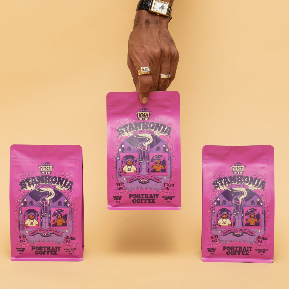 
                  
                    Three pink 'Stankonia' coffee bags held by a hand on a beige background
                  
                