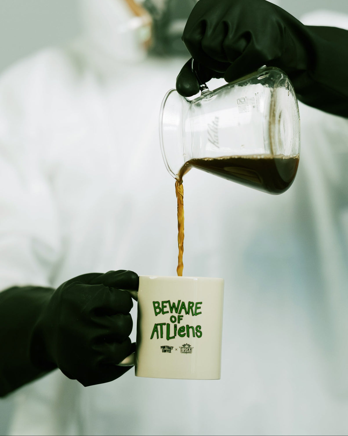 Pouring coffee into the Beware of ATLiens mug